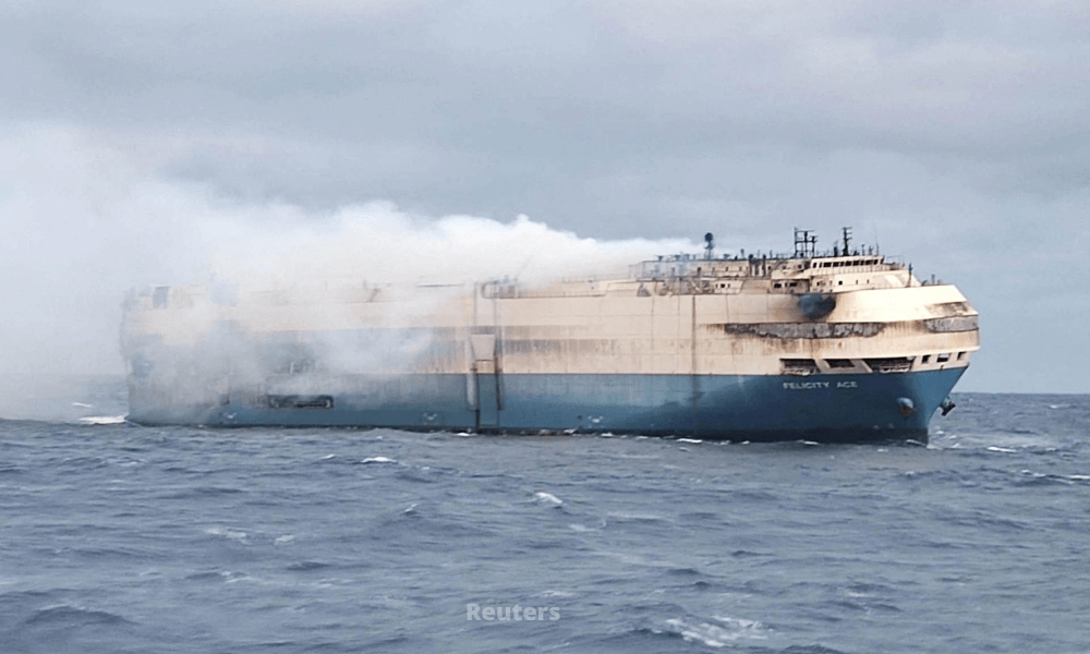 Firefighters battle a fire on a luxury automobile vessel off the coast of the Azores Islands